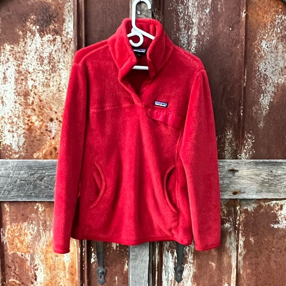 I’m selling a women’s red Patagonia fleece pullover jacket. Size large